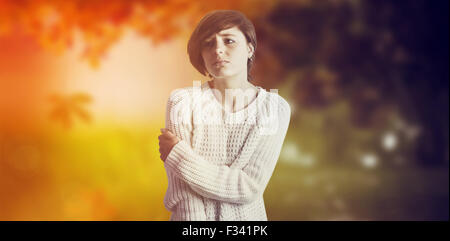 Composite image of sad pretty brunette leaning against wall Stock Photo