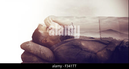 Composite image of man suffering from headache while on sofa Stock Photo