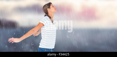 Composite image of side view of relaxed woman with arms outstretched Stock Photo