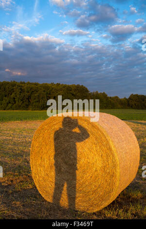 my shadow on a hay bale, Pays de Bergerac, Périgord, Dordogne, Aquitaine, France Stock Photo