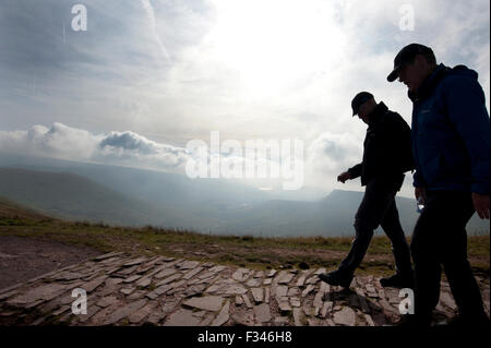 Brecon Beacons, UK. 29th September, 2015. Walkers enjoyed the early morning autumn sun, as they climbed up to admire clear panoramic views. Pen Y Fan is the highest mountain in south Wales and indeed the southern part of the United Kingdom. Credit:  roger tiley/Alamy Live News Stock Photo