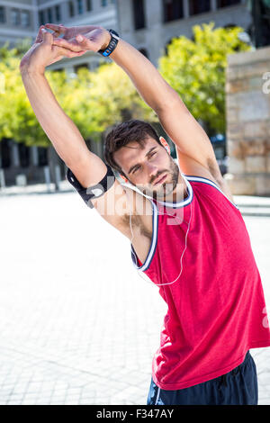 Handsome athlete doing arms stretching Stock Photo