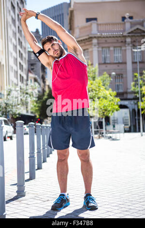 Handsome athlete doing arms stretching Stock Photo