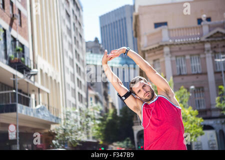 Handsome athlete doing arms stretching Stock Photo