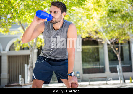 Handsome runner drinking fresh water Stock Photo