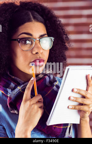 Attractive focused hipster taking notes Stock Photo
