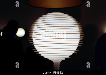 Abstract image of glowing glass lamp with stripes on dark background. Stock Photo