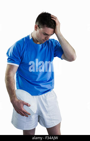 Disappointed rugby player holding his head Stock Photo