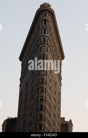 The Flatiron building sits on a triangular block formed by Fifth Avenue, Broadway and East 22nd Street, with 23rd Street in NYC Stock Photo