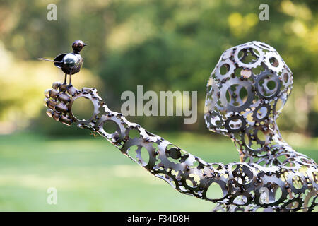 Bird on the hand 'Jacqueline' Sculpture by Darren Greenhow at RHS Wisley Gardens, Surrey, England Stock Photo