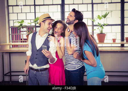 Group of friends looking at a smartphone Stock Photo