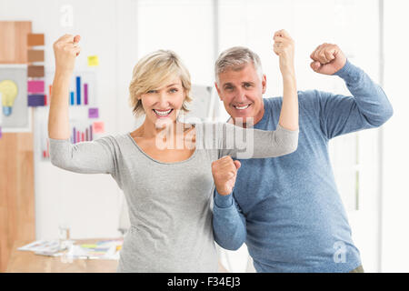 Happy business colleagues gesturing victory Stock Photo