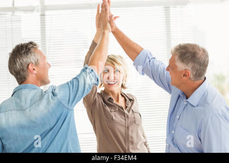 Smiling business colleagues giving high-five Stock Photo