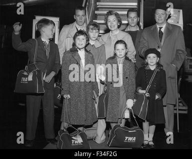 Dec. 26, 1976 - Idlewild Airport New York: Off to Madrid VIA TWA Super G Fly the Farrow Family from Hollywood. Father John Farrow, is famed movie director and he is headed for Spain to start shooting a Warner Bros. Picture on the life of John Paul Jones, The American Naval Hero. Mrs. Farrow is movie actress Maureen O'Sullivan. The seven children are left to right: Front Row: John, Age 11; Prudence, Age 9; Stephanie, Age 3; Therese, Age 6; Left to right back row: Pat, Age 15; Mia, Age 13; Maureen O'Sullivan, Michael, Age 18; and John Farrow Senior. (Credit Image: © Keystone Pictures USA/ZUMAPRE Stock Photo