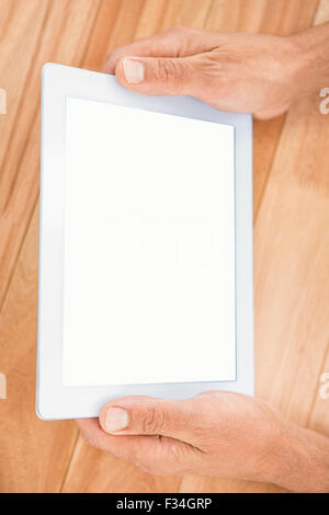Hands holding a tablet at a desk, blank screen Stock Photo - Alamy