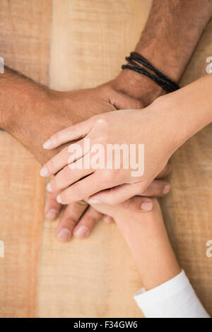 Casual business colleagues stacking their hands Stock Photo