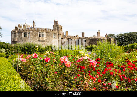 Walmer Tudor castle built in 1540 with the Kitchen Garden in the foreground, growing vegeables and roses. Blue and white cloudy sky overhead. Stock Photo