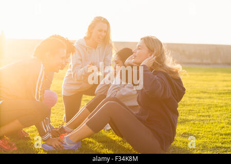 Sporty women doing sit ups during fitness class Stock Photo