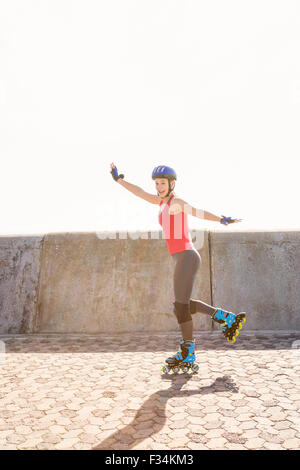 Carefree sporty blonde skating Stock Photo
