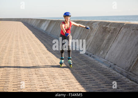 Carefree sporty blonde skating Stock Photo