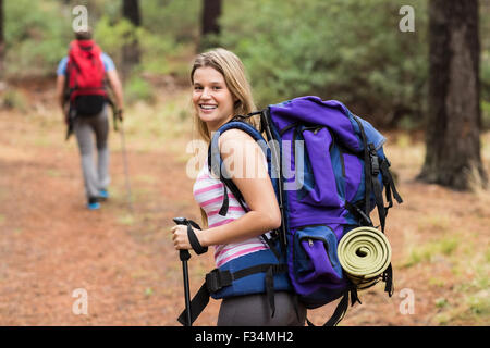 Portrait of happy young woman hiking in the mountains stock photo