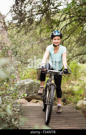 Smiling fit woman taking a break on her bike Stock Photo