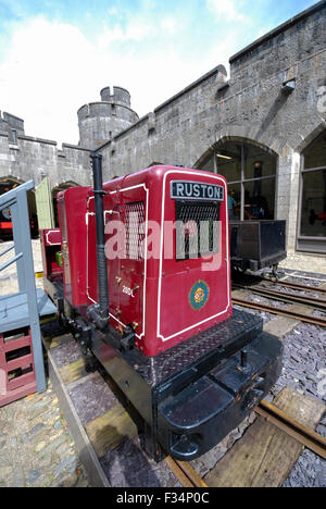 A historic Ruston 2 cylynder narrow gauge diesel locomotive used for hauling slate. The small train engine is on display at Penrhyn Castle in Wales Stock Photo