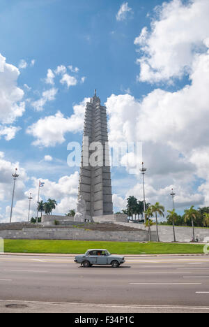 The an old Lada taxi passes by the José Martí Memorial and lookout adjacent to Revolution square in Havana Cuba