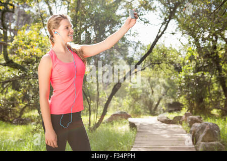 Smiling blonde athlete taking selfies Stock Photo - Alamy