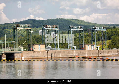 Sluice gate lifting gantry cranes stand on top of the Moore Reservoir power dam on the Connecticut River in NH, USA. Stock Photo