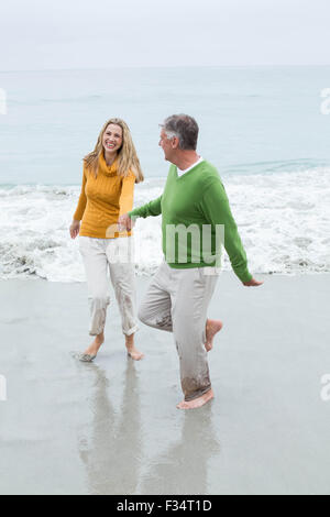 Happy couple holding hands and running Stock Photo