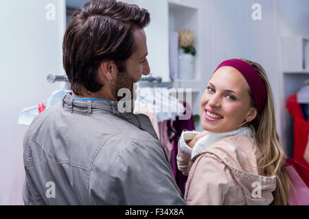 Smiling man having arm around girlfriend looking at camera Stock Photo
