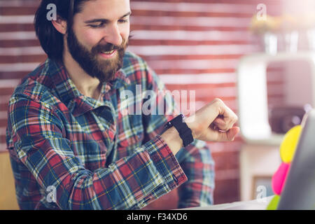 Smiling businessman checking time Stock Photo