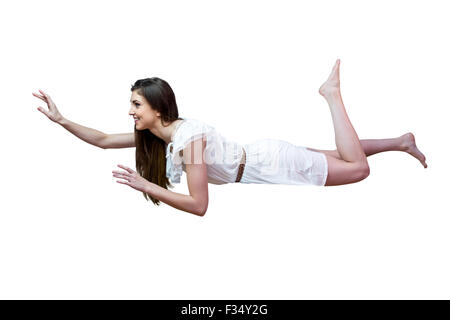 Girl in white dress floating in air Stock Photo