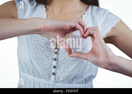 Woman making heart shape with hands Stock Photo