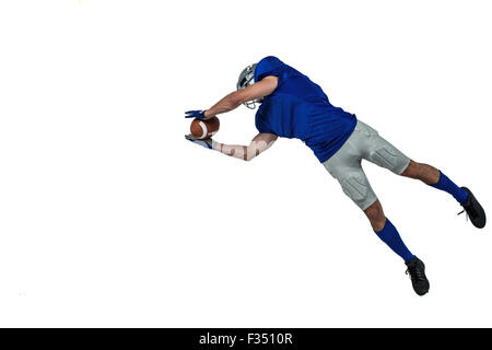 American football player catching ball in mid-air Stock Photo