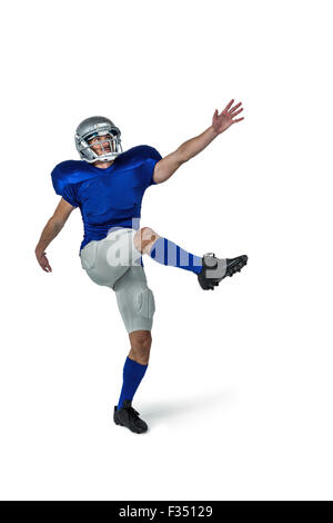 American football player kicking Stock Photo