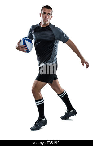 Sportsman running with ball Stock Photo