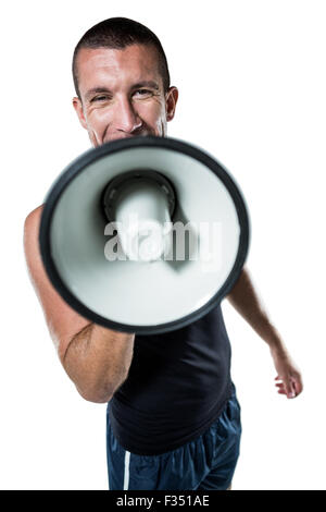 Male trainer yelling through megaphone Stock Photo