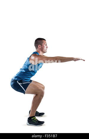 A Fit man doing squats Stock Photo