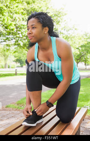 Woman tying her shoelace on running shoe Stock Photo