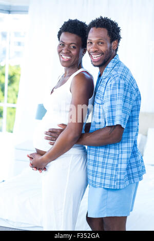 Portrait of man hugging his pregnant wife while standing Stock Photo ...