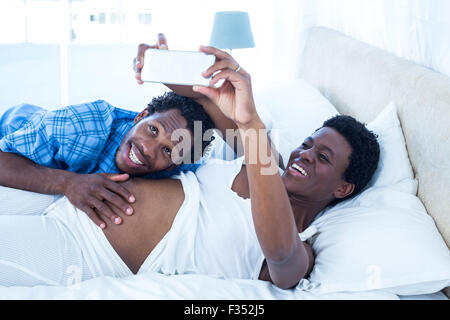 Pregnant woman taking selfie while relaxing Stock Photo