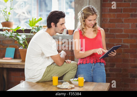 Businesswoman pointing towards digital table in office Stock Photo