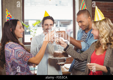 Colleagues toasting with champagne at birthday party Stock Photo