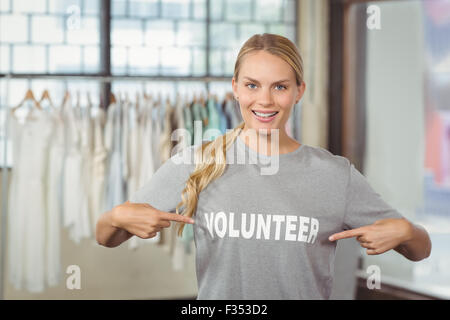 Portrait of happy woman showing volunteer text on tshirt Stock Photo