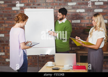 Colleagues working during presentation Stock Photo