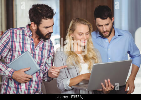 Man pointing towards laptop Stock Photo