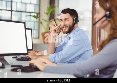 Thoughtful man working while sitting in office Stock Photo