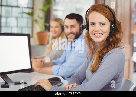 Portrait of smiling operators working in office Stock Photo